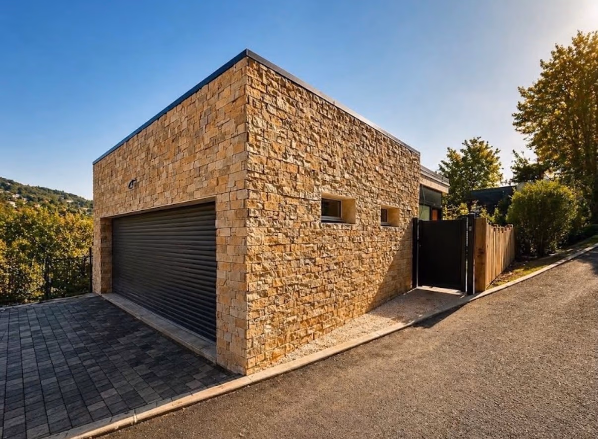 Maison contemporaine habillée d’un parement en pierre naturelle aux teintes chaudes avec garage